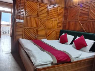 a bed room with chair at hill view in nainital